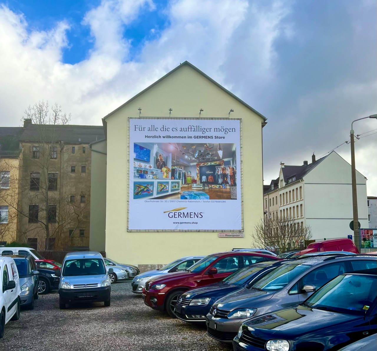 GERMENS-Plakat mit Innenaufnahme des Stores und Einladung zum Besuch